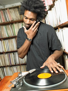 Male DJ playing record in music shop